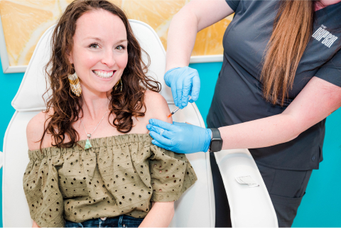 Female in chair receiving iv drip 